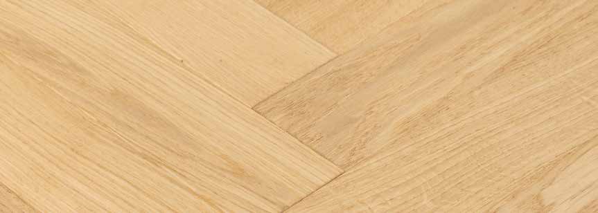 Détail d’un parquet clair en chevrons avec veinage apparent